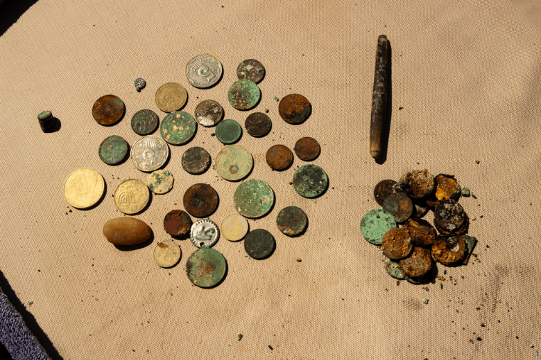 Gold and silver coins collected with the help of an underwater metal detector